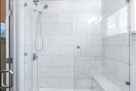 a bathroom with a granite countertop sink a toilet and shower