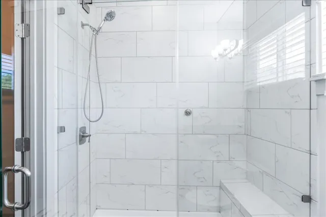 a bathroom with a granite countertop sink a toilet and shower