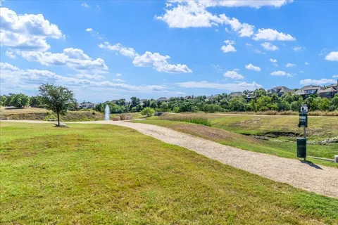 a view of a house with pool and trees in the background