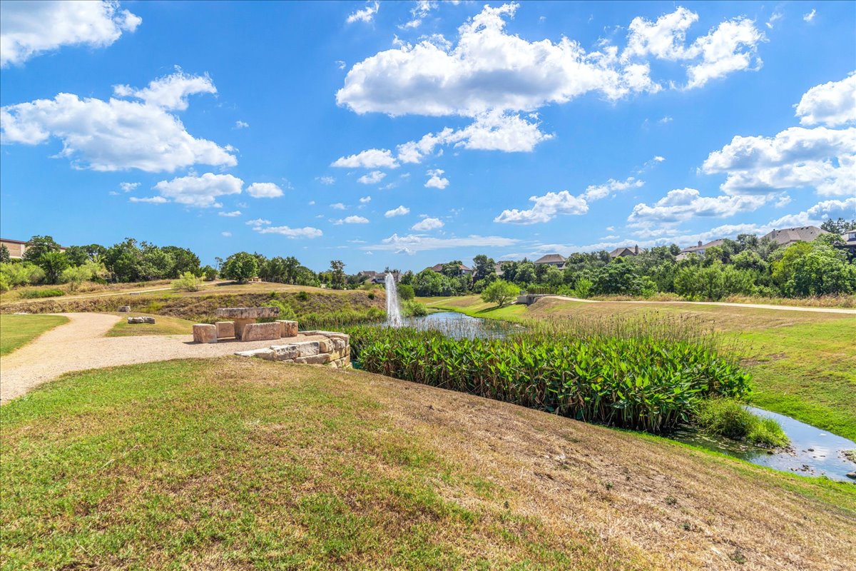 2021 Local Rebel Street, Unit 2021 Leander, TX 78641 - Photo 38 of 40 View of grassy yard featuring a water view