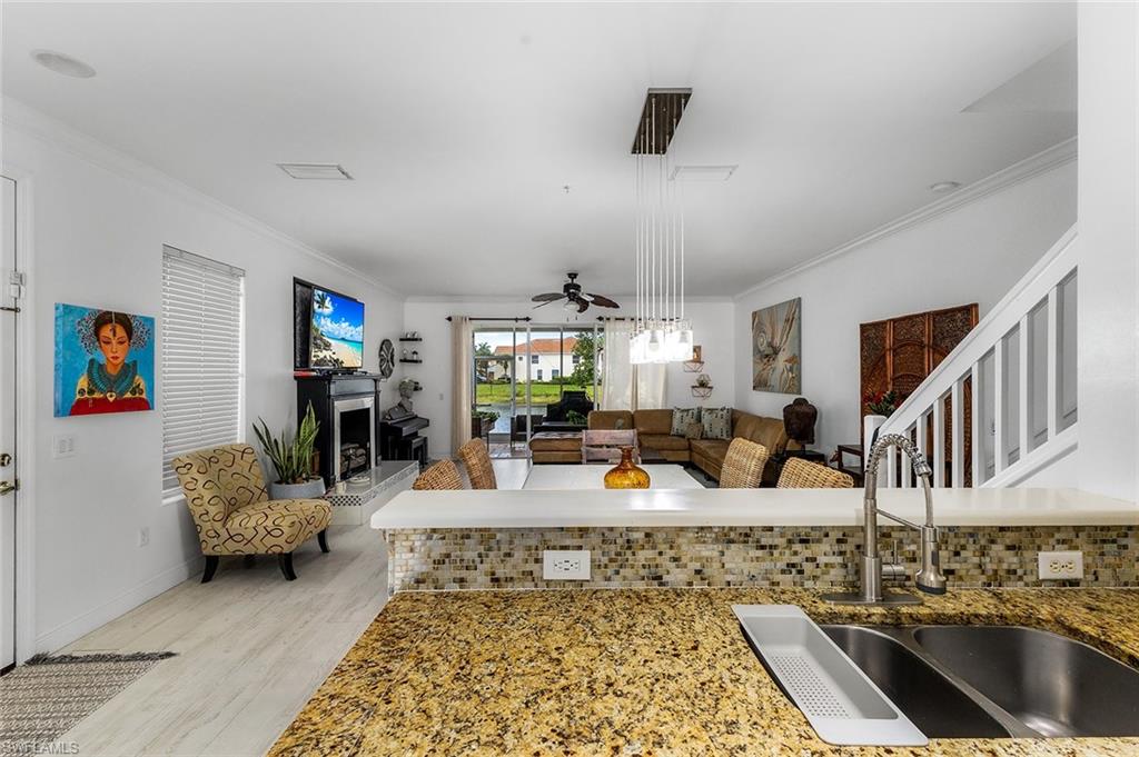 1064 Hampton Circle Naples, FL 34105 - Photo 11 of 32 a living room with furniture and a flat screen tv