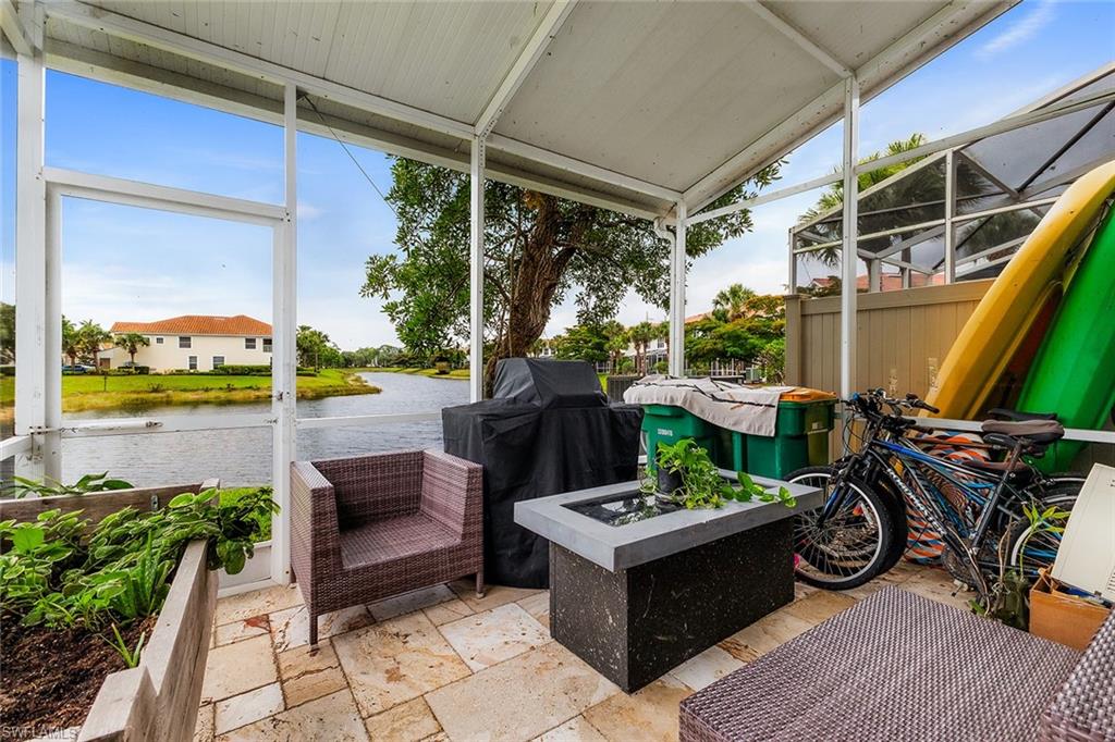 1064 Hampton Circle Naples, FL 34105 - Photo 12 of 32 a view of a patio with table and chairs potted plants with wooden floor