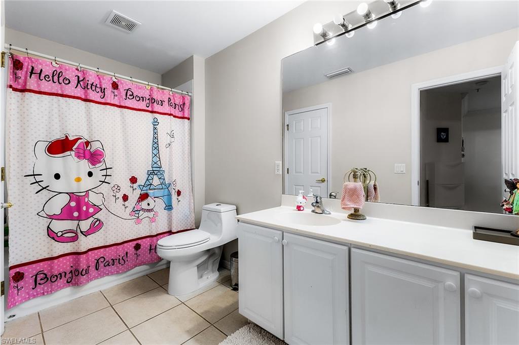 1064 Hampton Circle Naples, FL 34105 - Photo 24 of 32 a bathroom with a sink mirror and vanity