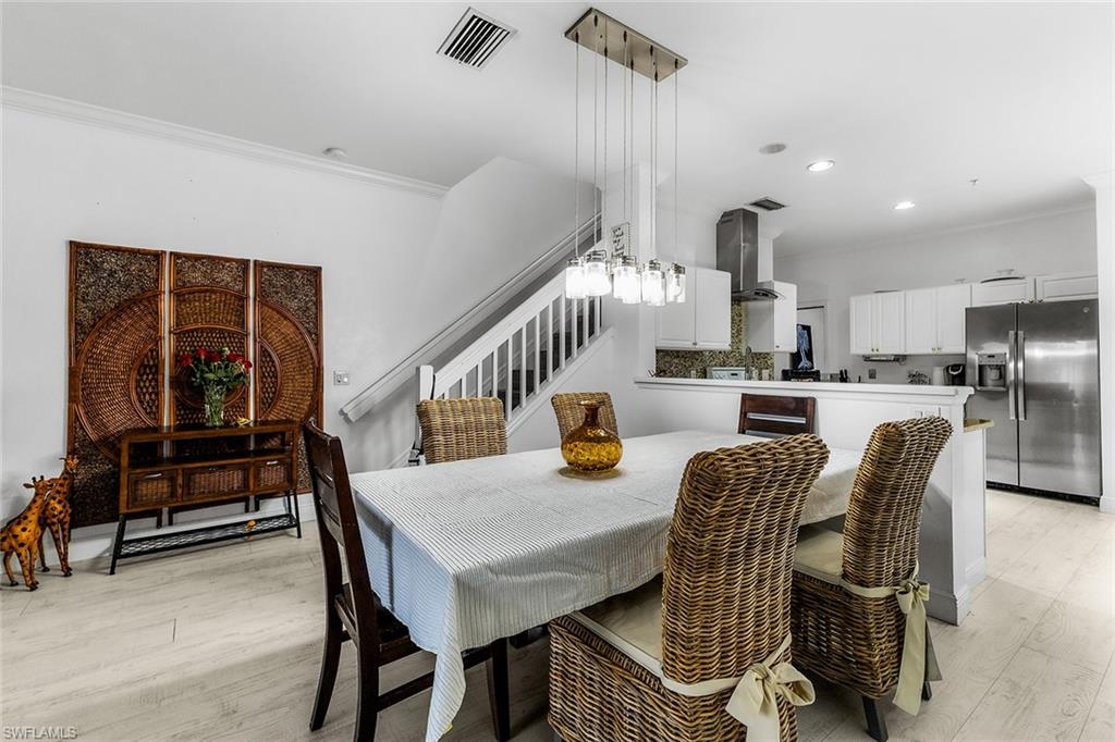 1064 Hampton Circle Naples, FL 34105 - Photo 3 of 32 a dining room with furniture and wooden floor