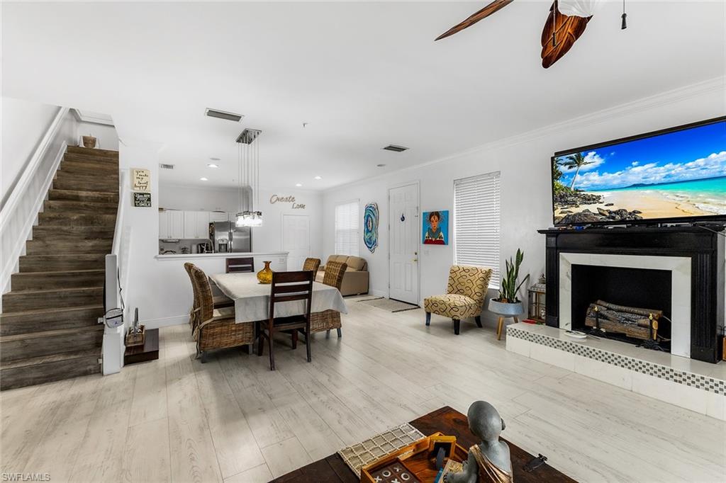 1064 Hampton Circle Naples, FL 34105 - Photo 8 of 32 a living room with furniture and a fireplace