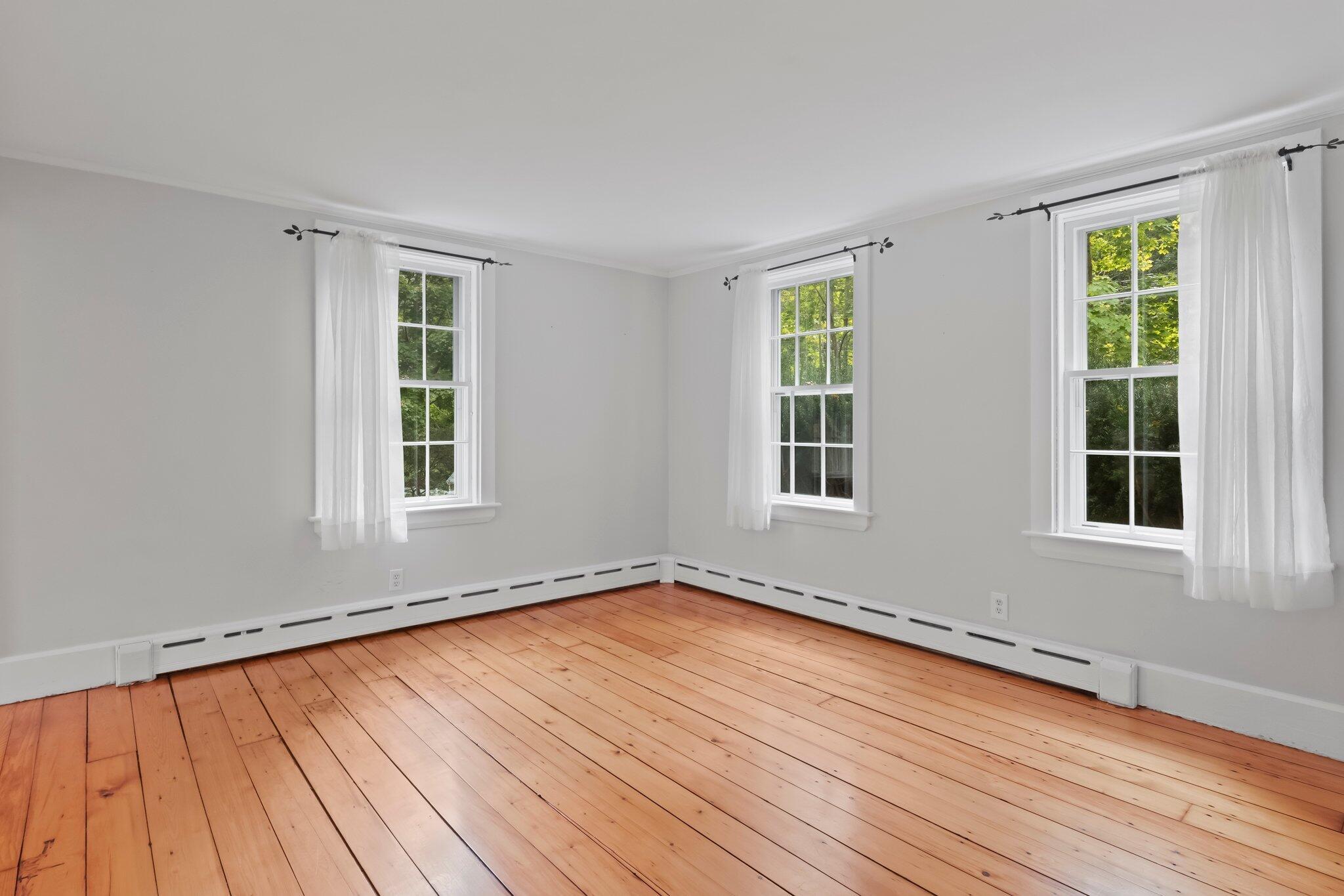 99 Main Street Sandwich, MA 02563 - Photo 12 of 43 an empty room with wooden floor and windows