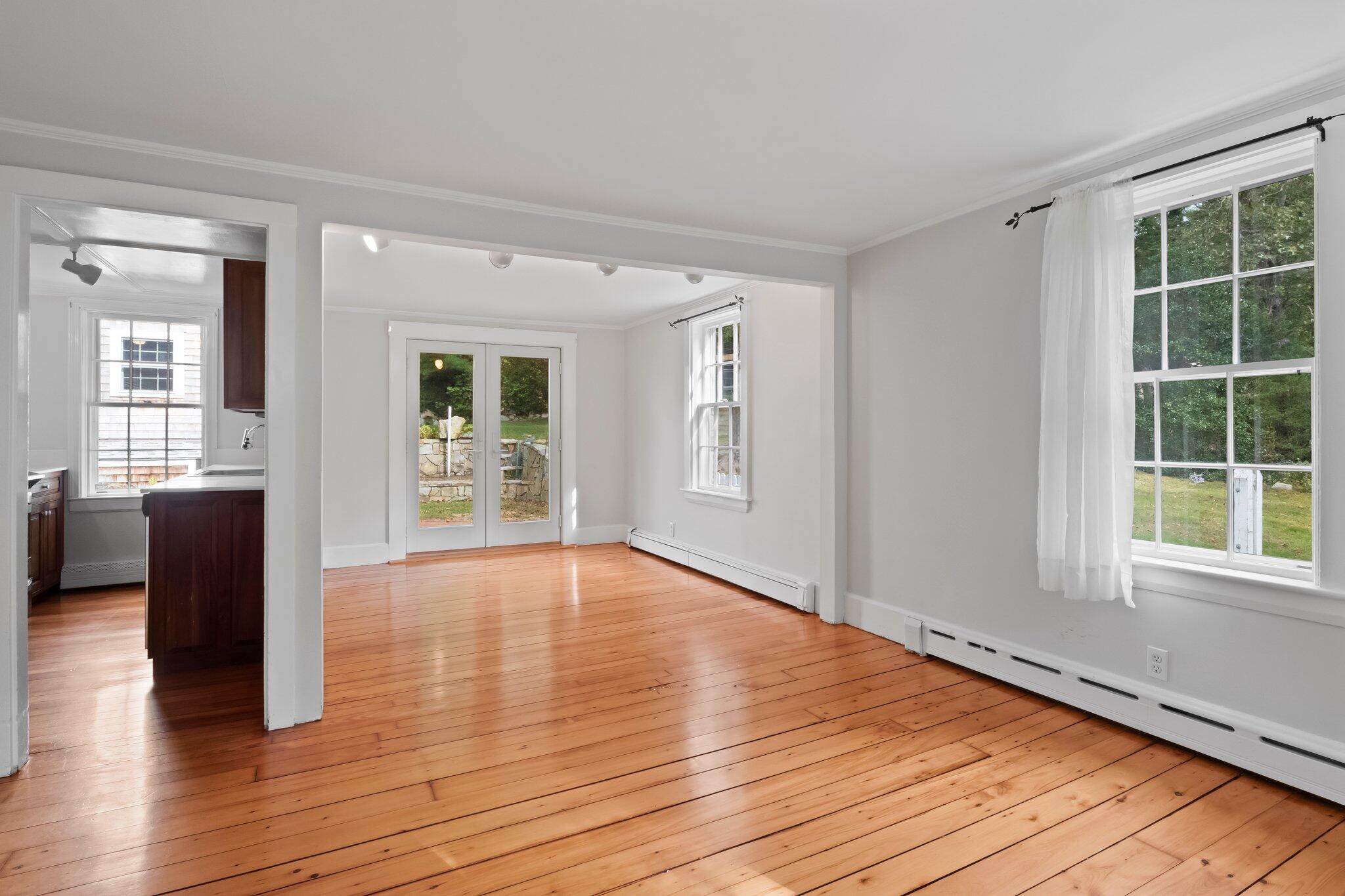 99 Main Street Sandwich, MA 02563 - Photo 13 of 43 a view of an empty room with wooden floor and a window