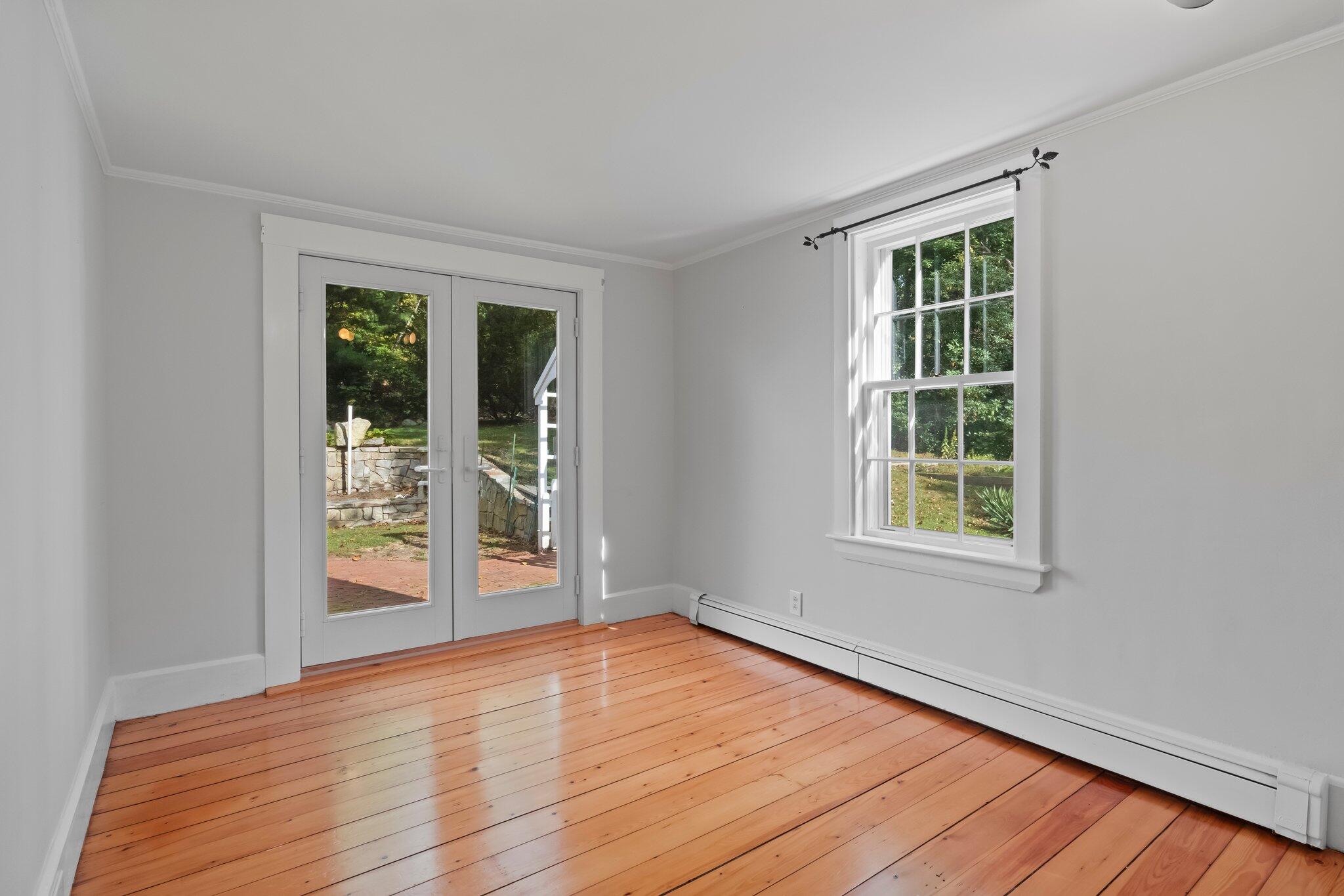 99 Main Street Sandwich, MA 02563 - Photo 14 of 43 an empty room with wooden floor and windows