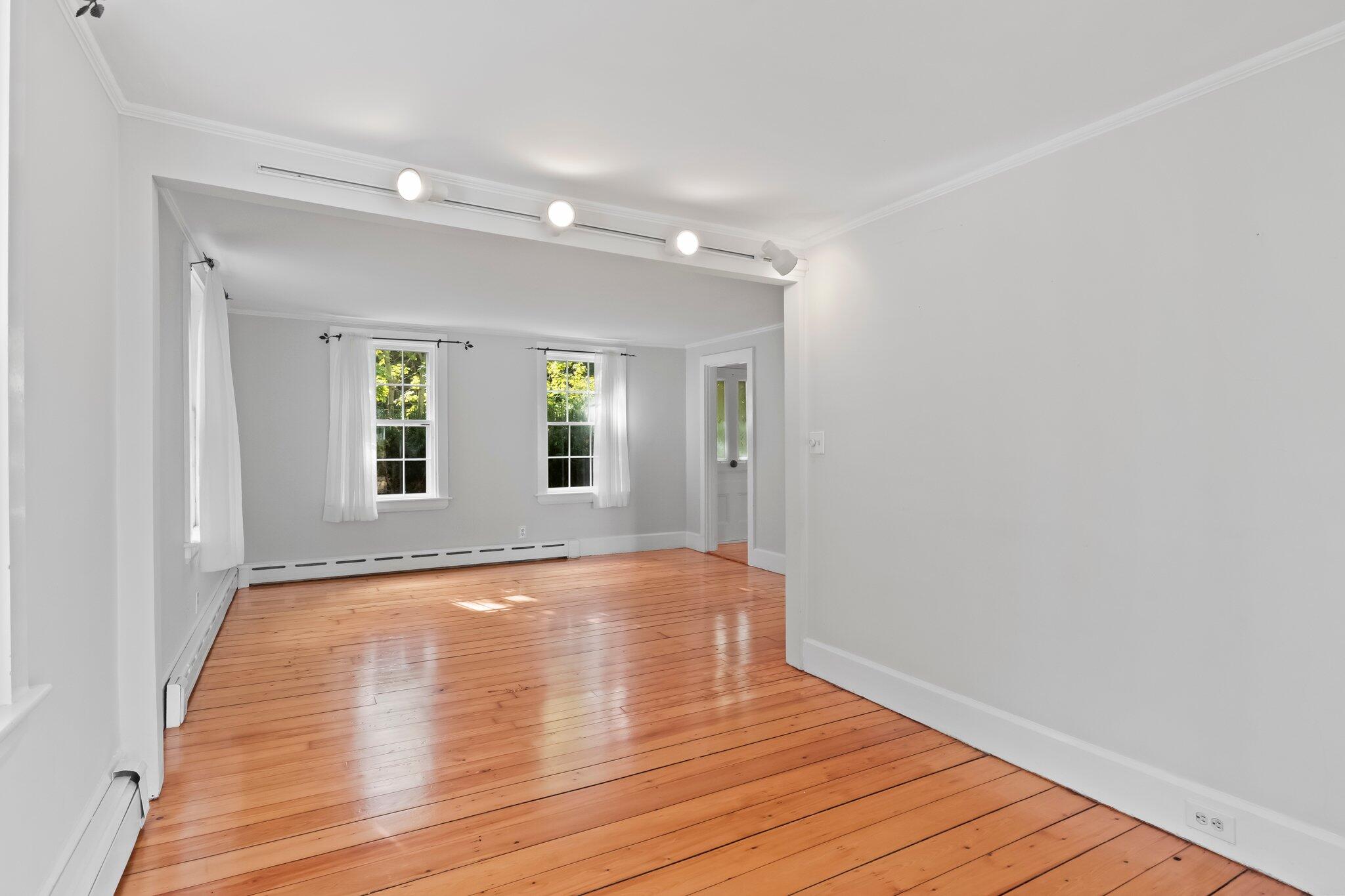 99 Main Street Sandwich, MA 02563 - Photo 15 of 43 a view of an empty room with wooden floor and a window