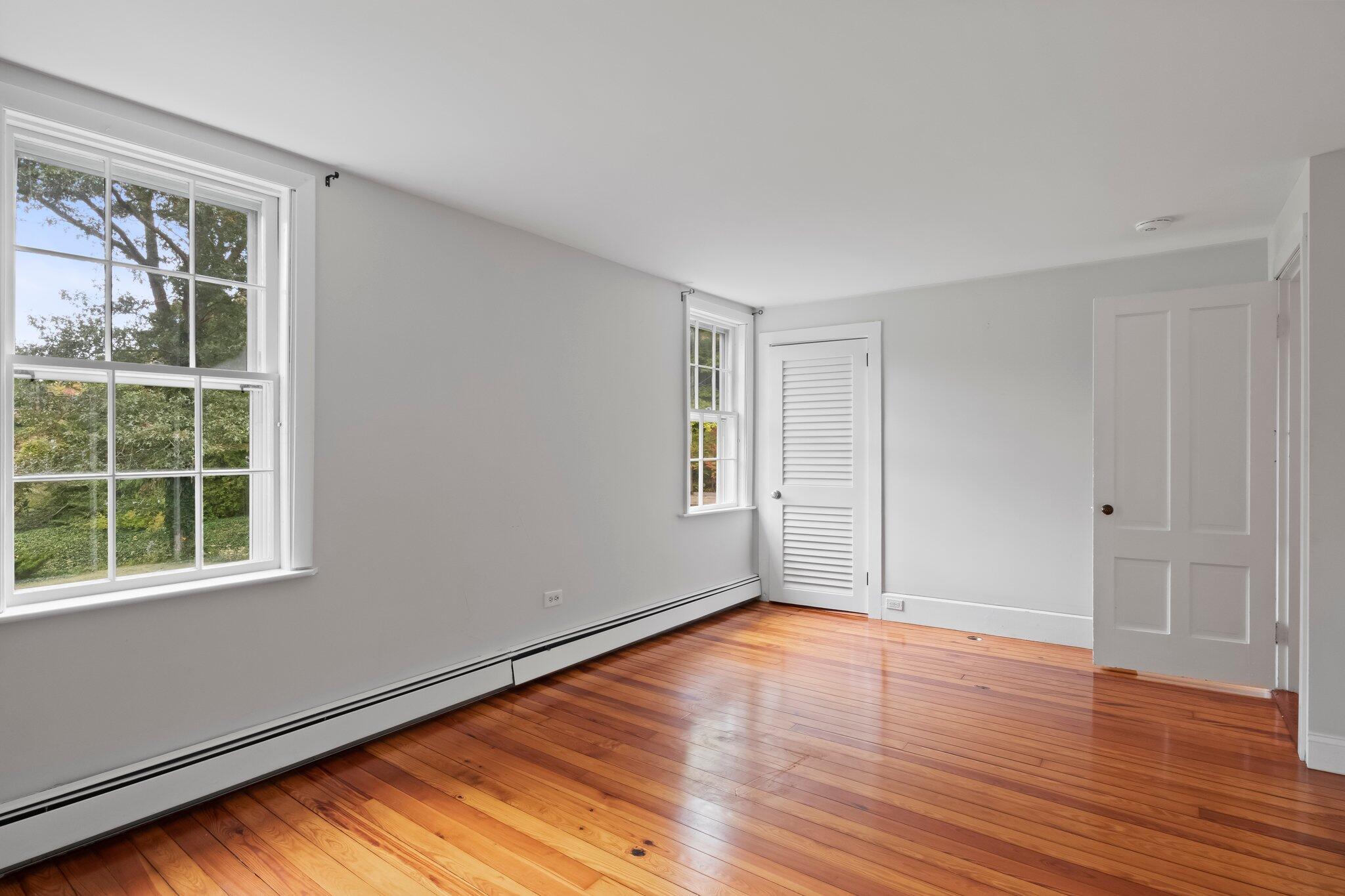 99 Main Street Sandwich, MA 02563 - Photo 21 of 43 a view of empty room with wooden floor and fan