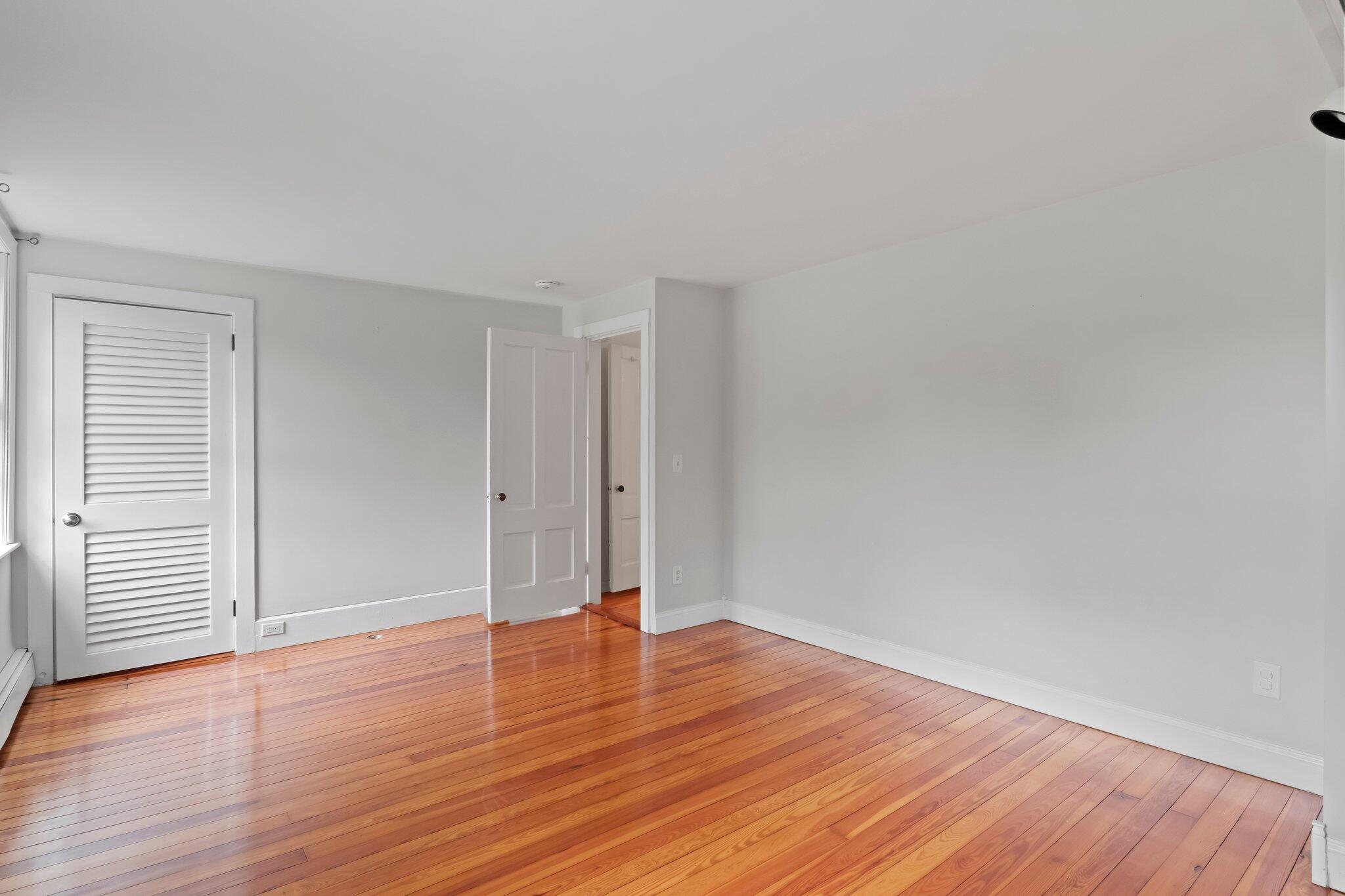 99 Main Street Sandwich, MA 02563 - Photo 22 of 43 an empty room with wooden floor and windows