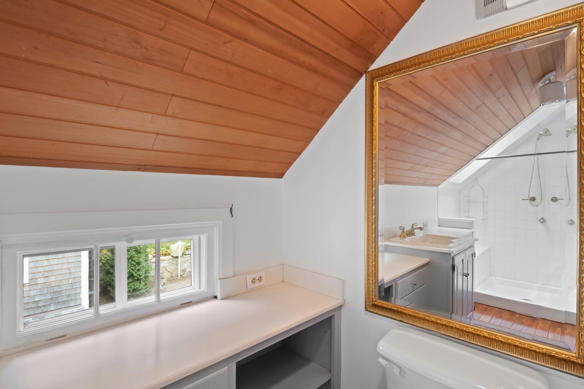 99 Main Street Sandwich, MA 02563 - Photo 24 of 43 a room with a bed and a large window with garden view