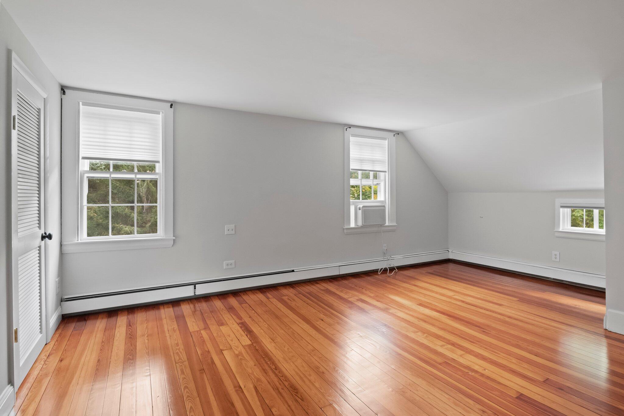 99 Main Street Sandwich, MA 02563 - Photo 25 of 43 an empty room with wooden floor and windows