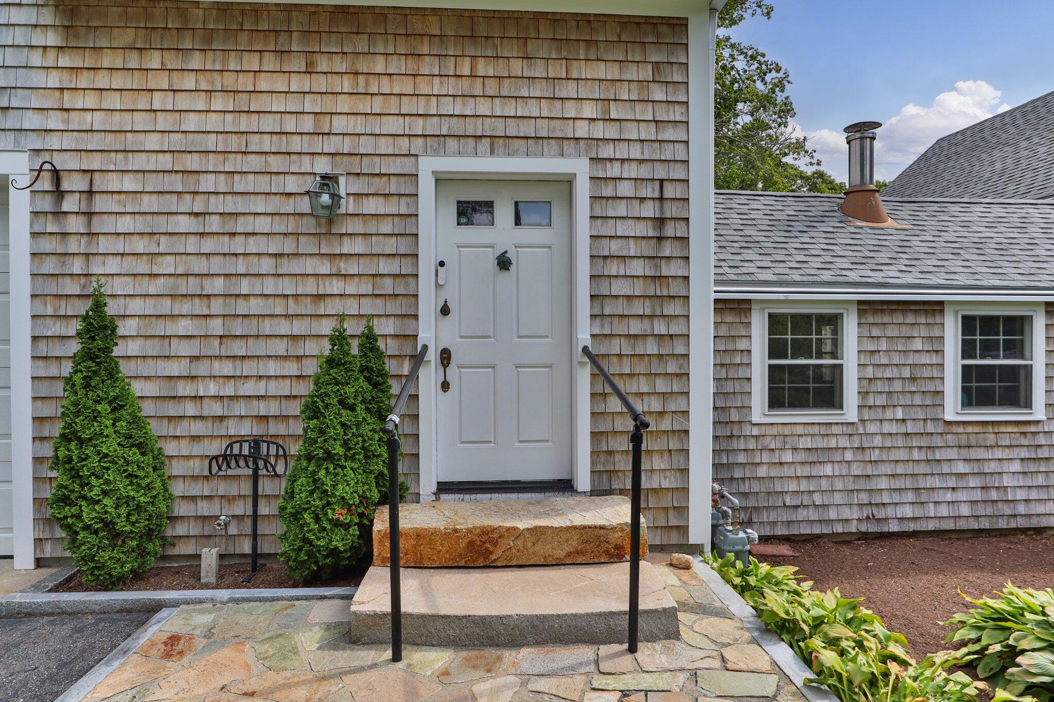 99 Main Street Sandwich, MA 02563 - Photo 3 of 43 a view of a brick house with a large windows