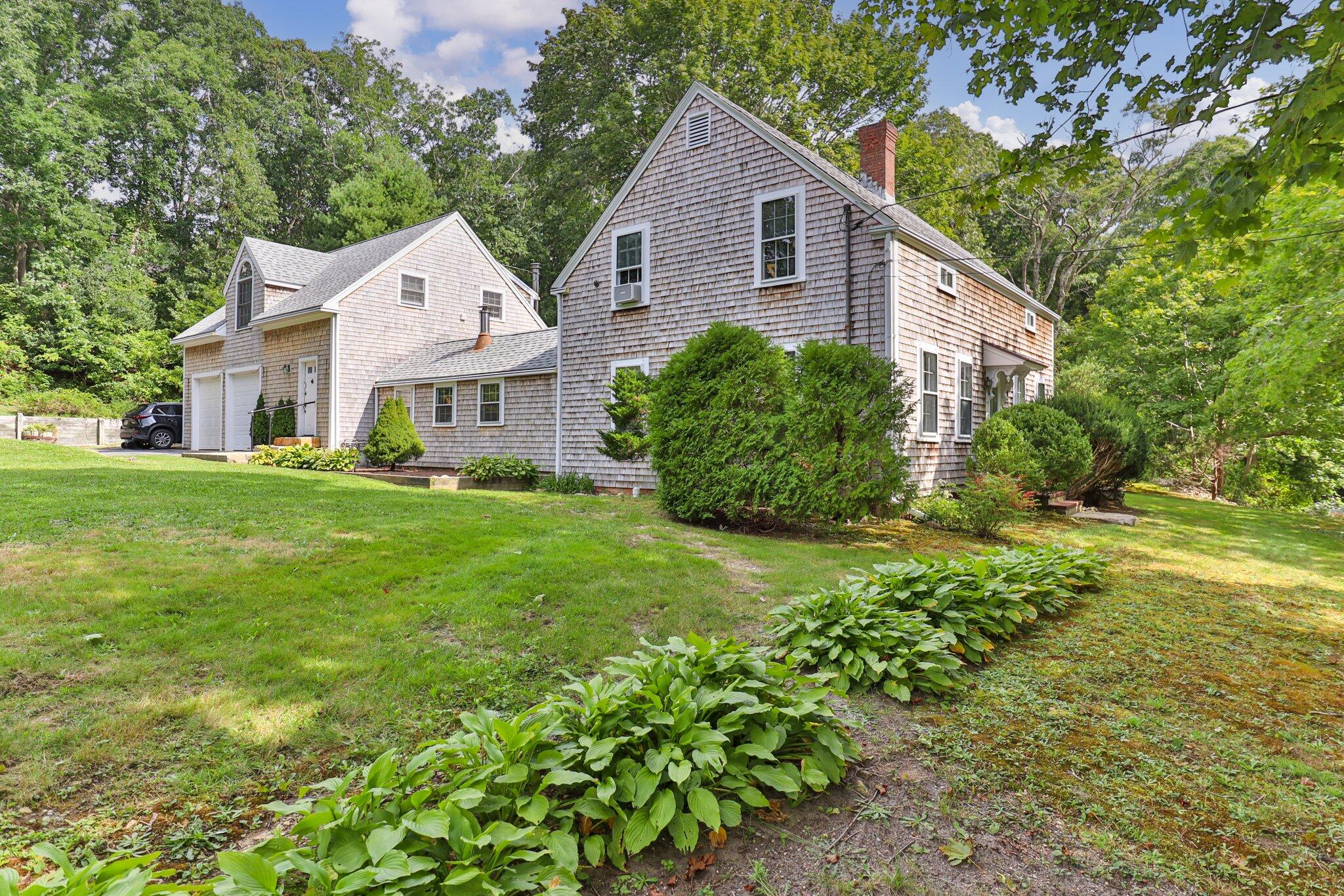 99 Main Street Sandwich, MA 02563 - Photo 4 of 43 a view of a house with backyard and garden