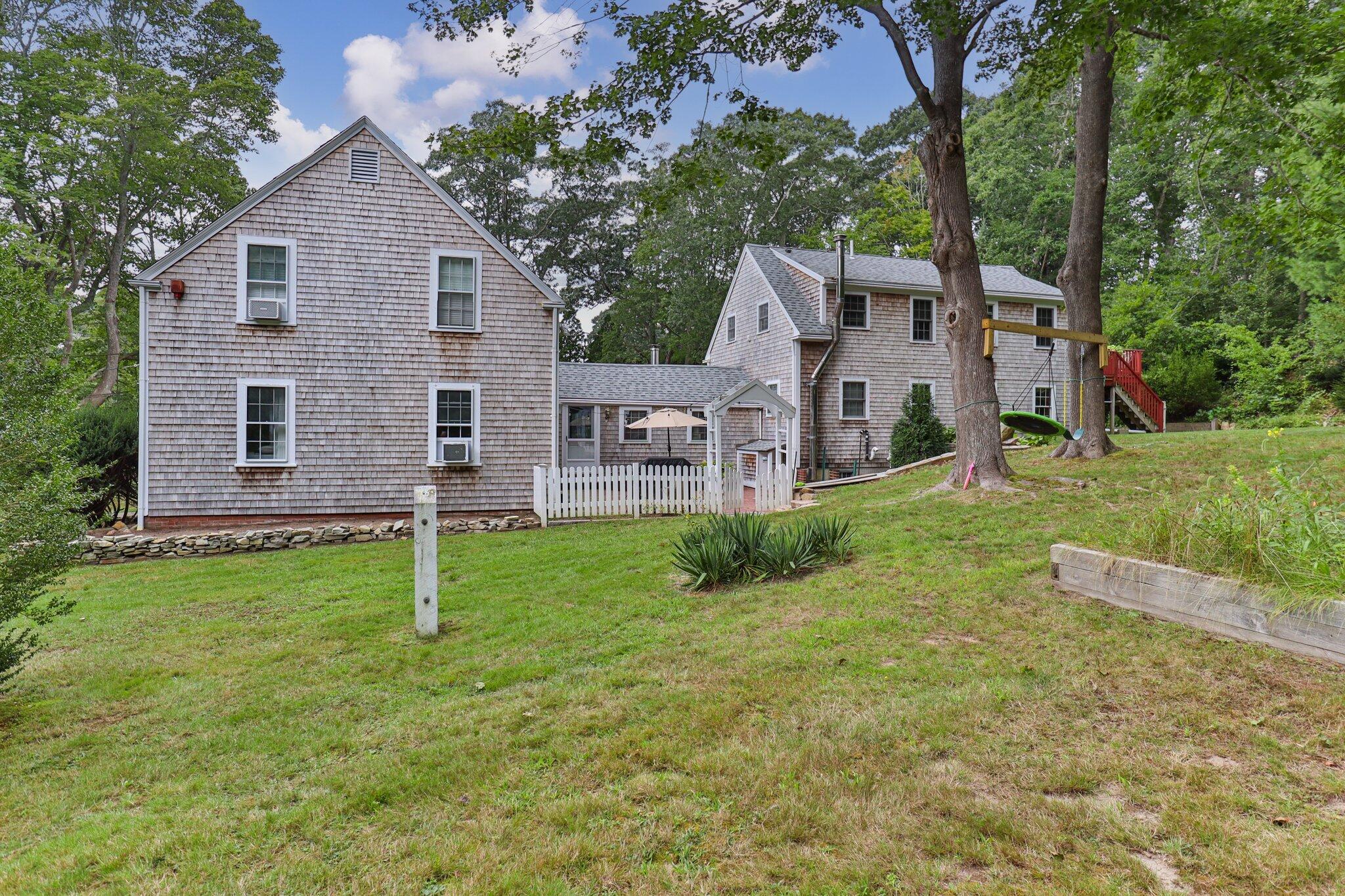 99 Main Street Sandwich, MA 02563 - Photo 7 of 43 front view of a house with a yard