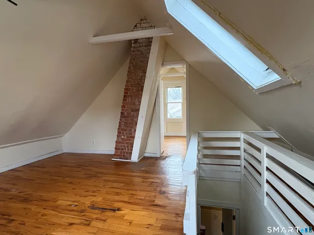 a view of an entryway with wooden floor