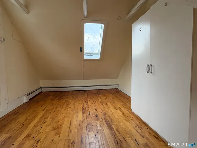 a view of a room with wooden floor and small space