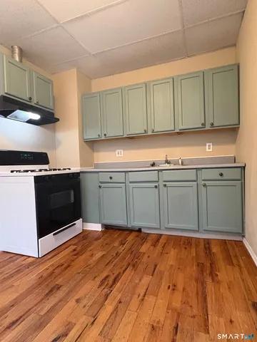 a kitchen with wooden cabinets and a sink