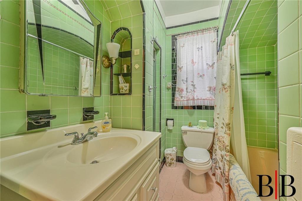 2219 83rd Street Brooklyn, NY 11214 - Photo 11 of 25 a bathroom with a sink toilet and shower