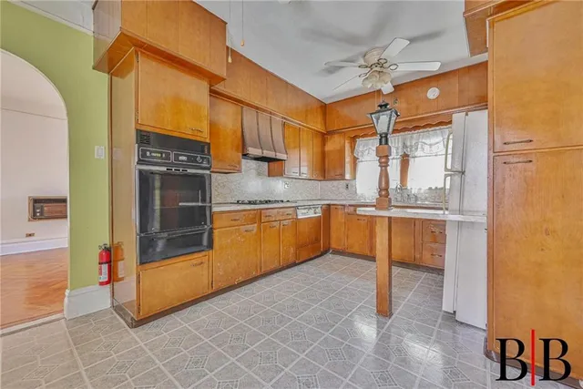 a kitchen with stainless steel appliances granite countertop a sink and a refrigerator