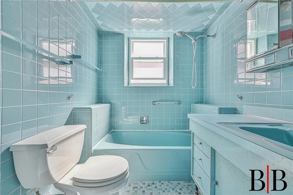 2219 83rd Street Brooklyn, NY 11214 - Photo 15 of 25 a bathroom with a sink toilet and shower