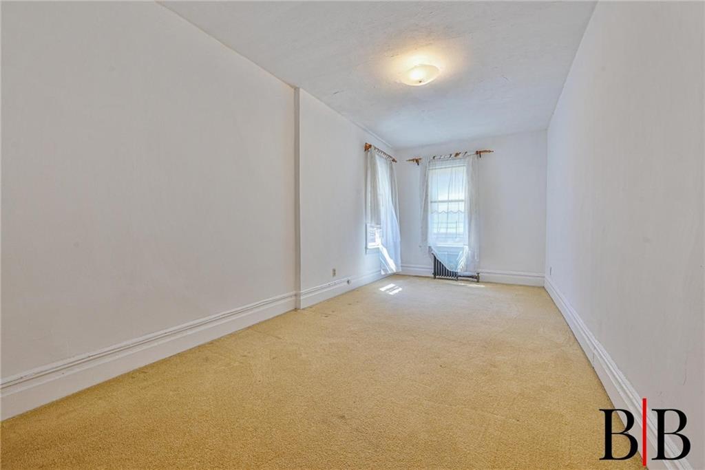 2219 83rd Street Brooklyn, NY 11214 - Photo 18 of 25 an empty room with windows and closet