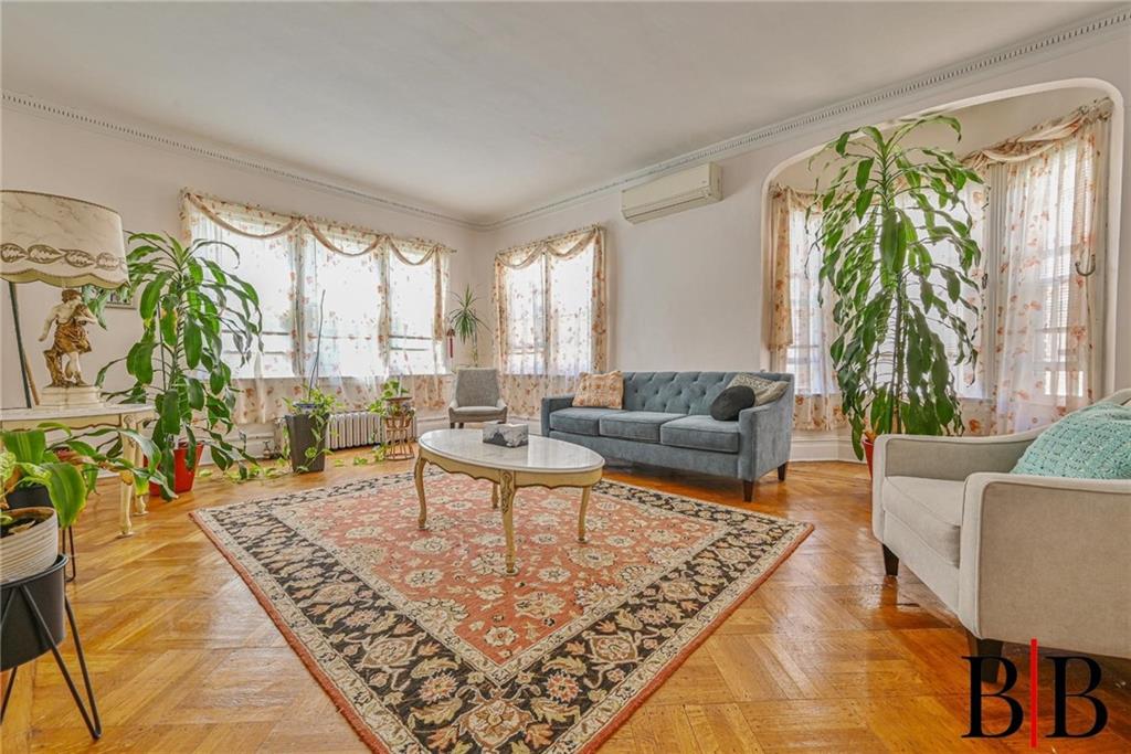 2219 83rd Street Brooklyn, NY 11214 - Photo 4 of 25 a living room with furniture and a large window