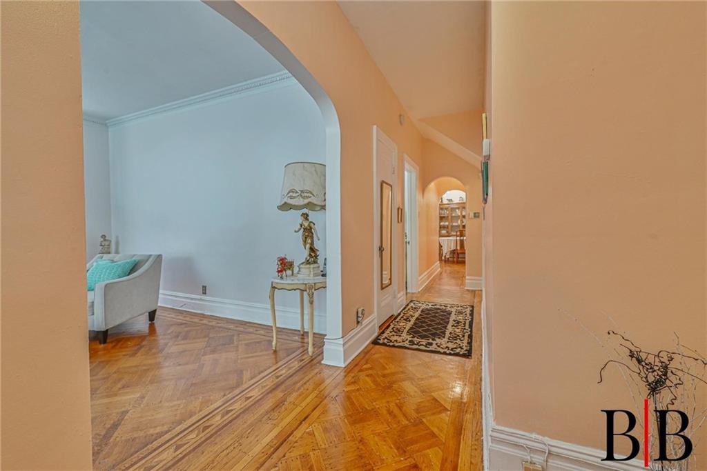 2219 83rd Street Brooklyn, NY 11214 - Photo 5 of 25 a view of a hallway with wooden floor and a living room