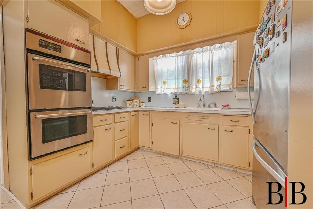 2219 83rd Street Brooklyn, NY 11214 - Photo 9 of 25 a kitchen with cabinets stainless steel appliances and sink
