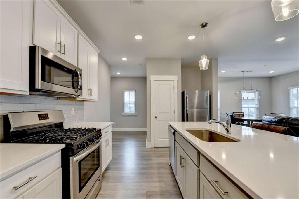 1714 Prospect Way Conyers, GA 30094 - Photo 11 of 35 a kitchen with stainless steel appliances a sink a stove and cabinets