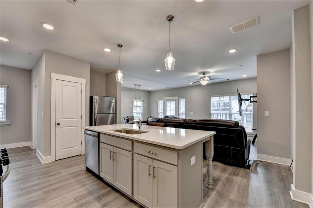 1714 Prospect Way Conyers, GA 30094 - Photo 14 of 35 a kitchen with granite countertop a sink stainless steel appliances and white cabinets