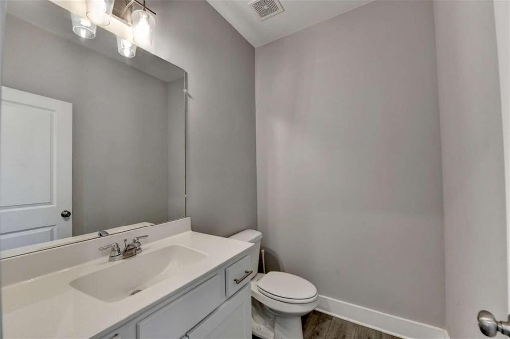 1714 Prospect Way Conyers, GA 30094 - Photo 15 of 35 a bathroom with a sink a toilet and a mirror