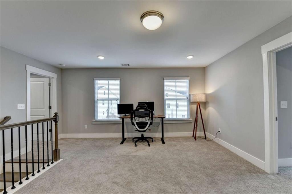1714 Prospect Way Conyers, GA 30094 - Photo 17 of 35 a view of a livingroom with a flesh screen tv and windows