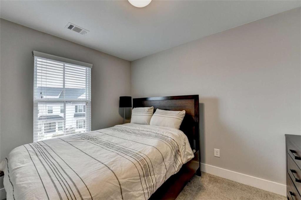 1714 Prospect Way Conyers, GA 30094 - Photo 20 of 35 a bedroom with a bed and a large window
