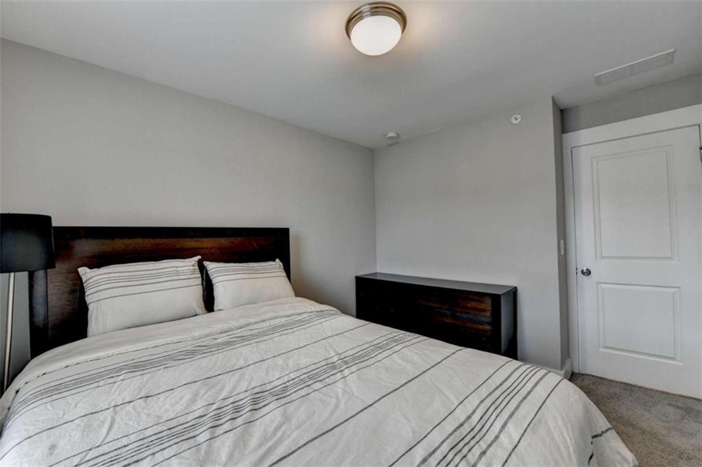 1714 Prospect Way Conyers, GA 30094 - Photo 21 of 35 a bedroom with a bed and a lamp