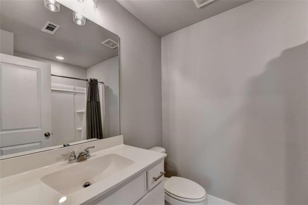 1714 Prospect Way Conyers, GA 30094 - Photo 22 of 35 a bathroom with a sink vanity mirror and toilet