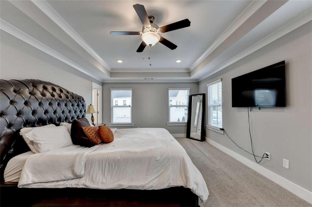 1714 Prospect Way Conyers, GA 30094 - Photo 25 of 35 a bedroom with a bed a tv and wooden floor