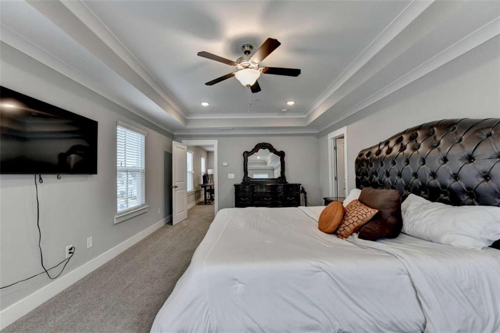 1714 Prospect Way Conyers, GA 30094 - Photo 27 of 35 a large bed sitting in a bedroom and flat screen tv with dresser