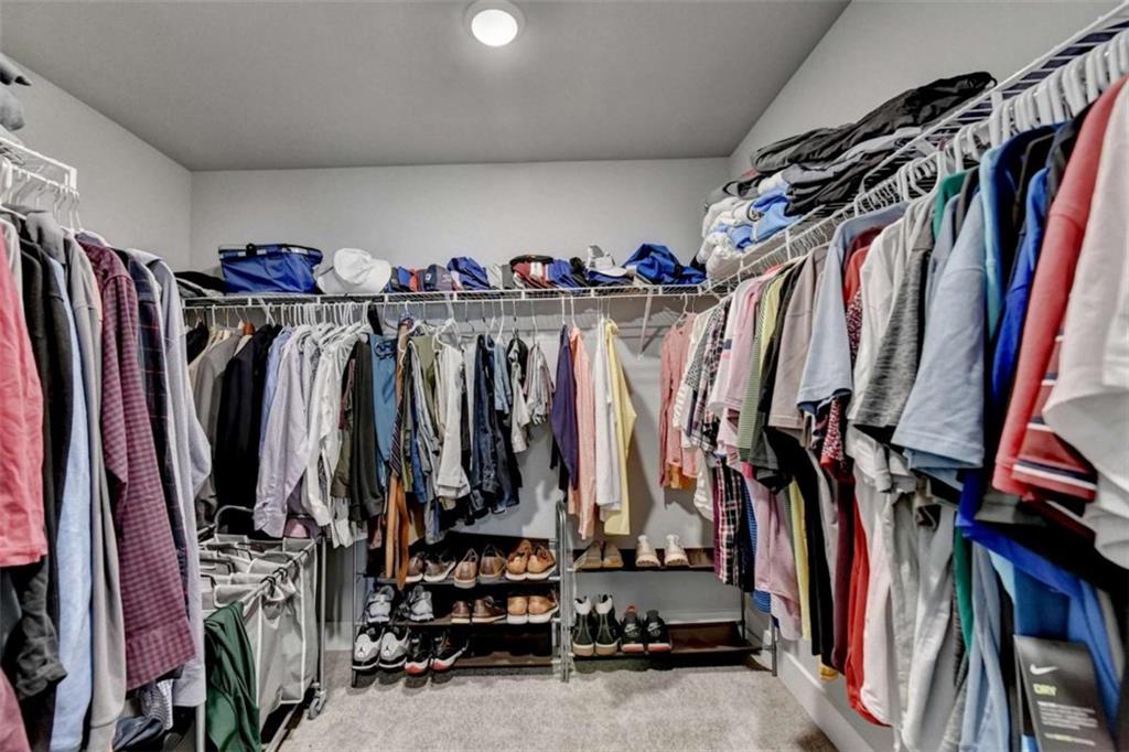 1714 Prospect Way Conyers, GA 30094 - Photo 28 of 35 a view of walk in closet with clothes
