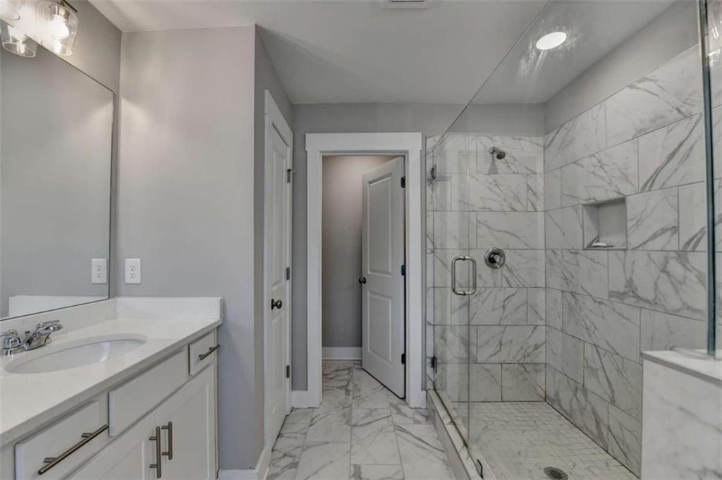 1714 Prospect Way Conyers, GA 30094 - Photo 29 of 35 a bathroom with a shower sink and mirror