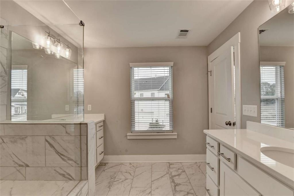 1714 Prospect Way Conyers, GA 30094 - Photo 30 of 35 a bathroom with a granite countertop sink mirror and a bathtub