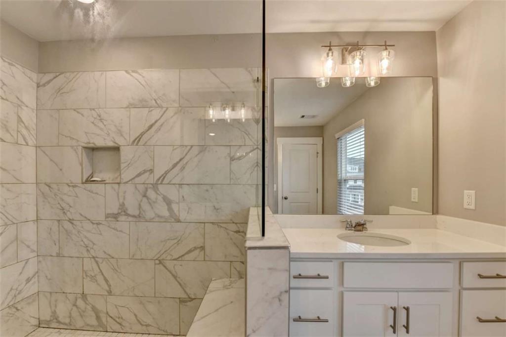1714 Prospect Way Conyers, GA 30094 - Photo 32 of 35 a bathroom with a sink shower and a mirror