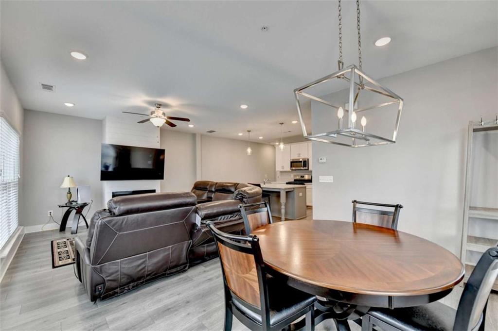 1714 Prospect Way Conyers, GA 30094 - Photo 6 of 35 a view of a dining room with furniture a chandelier and wooden floor