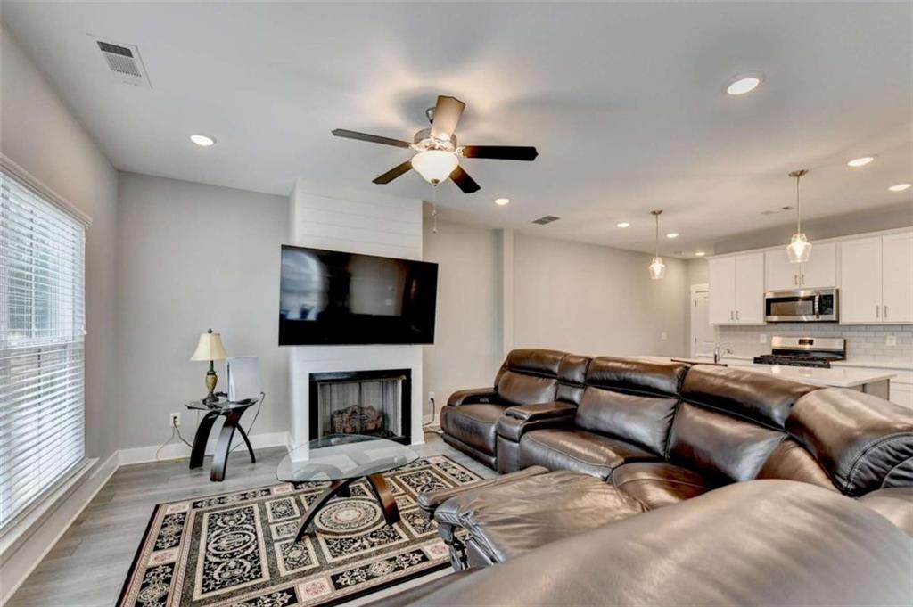 1714 Prospect Way Conyers, GA 30094 - Photo 7 of 35 a living room with furniture a flat screen tv and a fireplace