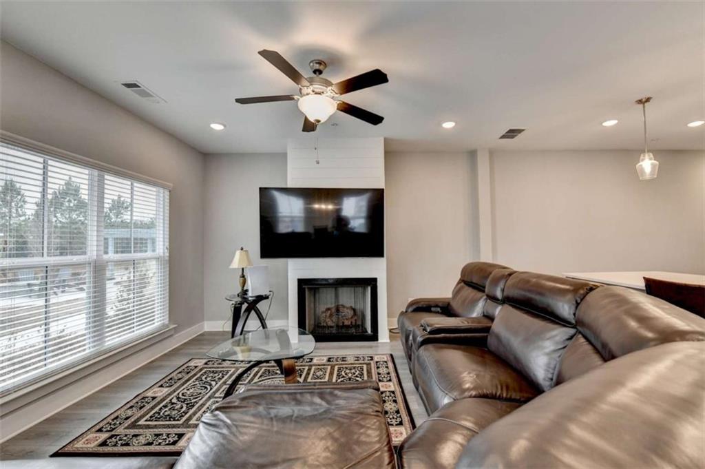 1714 Prospect Way Conyers, GA 30094 - Photo 8 of 35 a living room with furniture a flat screen tv and a fireplace