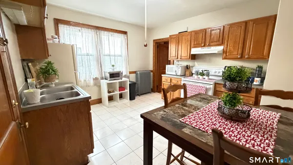 a bathroom with a sink a toilet and shower curtain