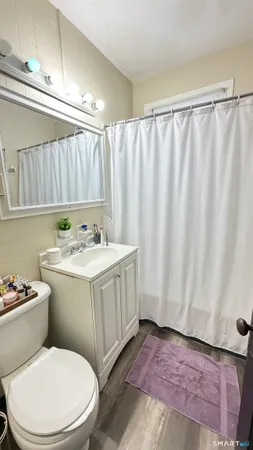 a bedroom with a bed and a night stand