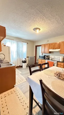 a kitchen with sink refrigerator and cabinets