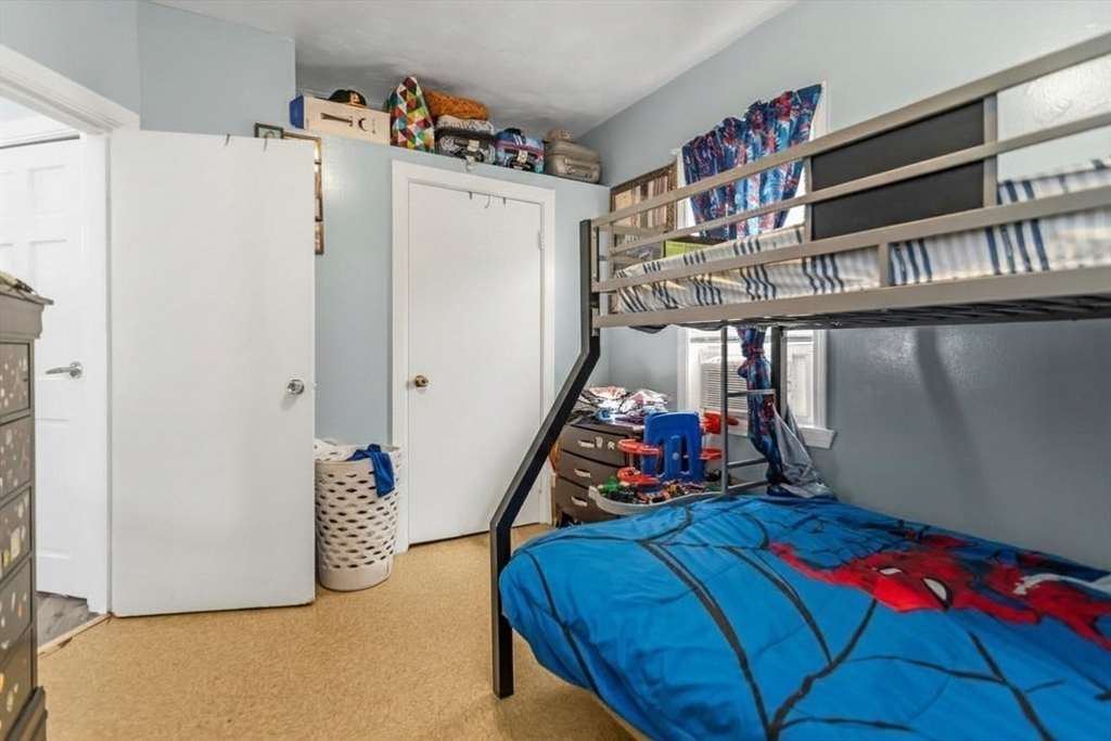 191 Farnham Street Lawrence, MA 01843 - Photo 14 of 31 a bedroom with bed and a refrigerator